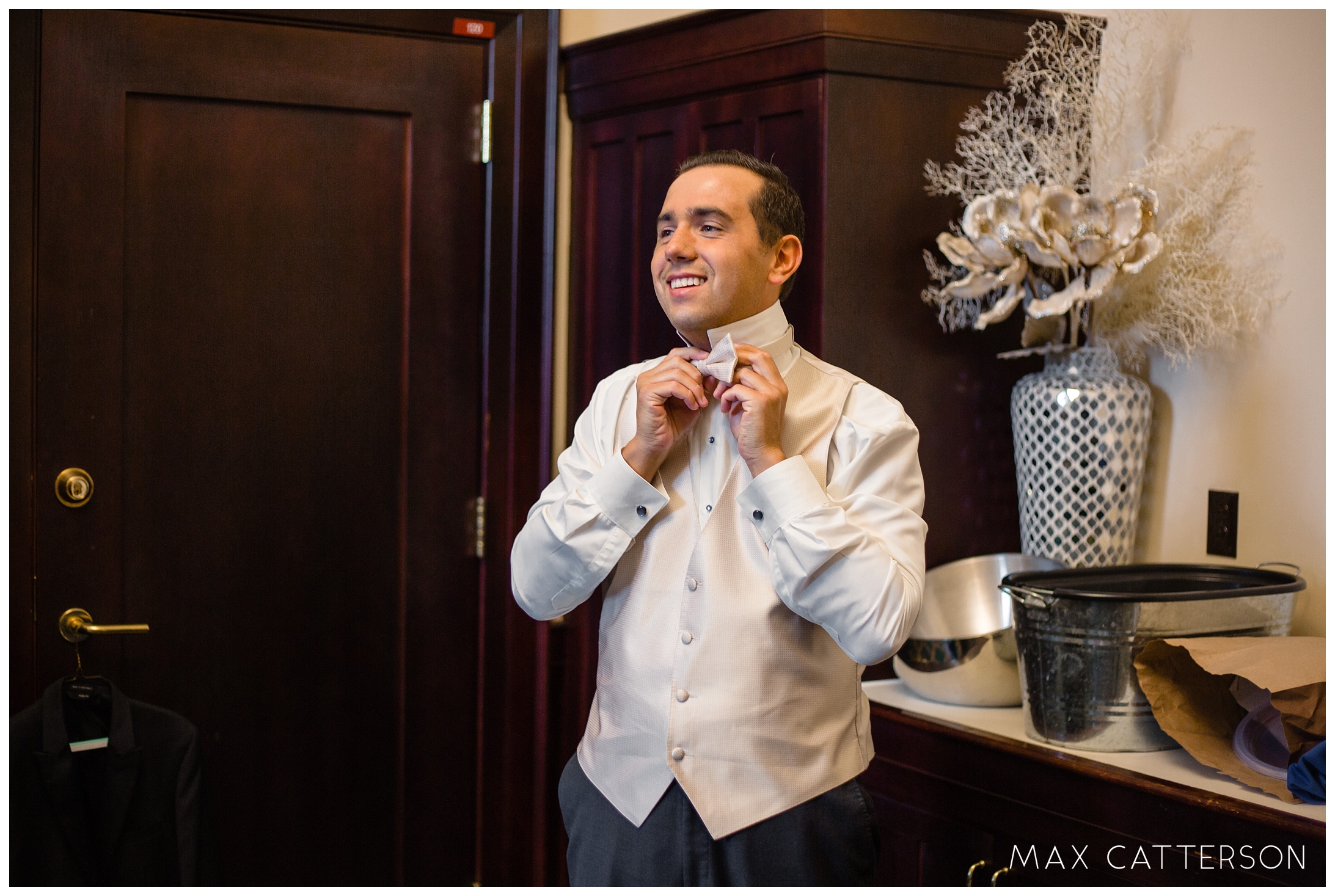 groom putting on bow tie