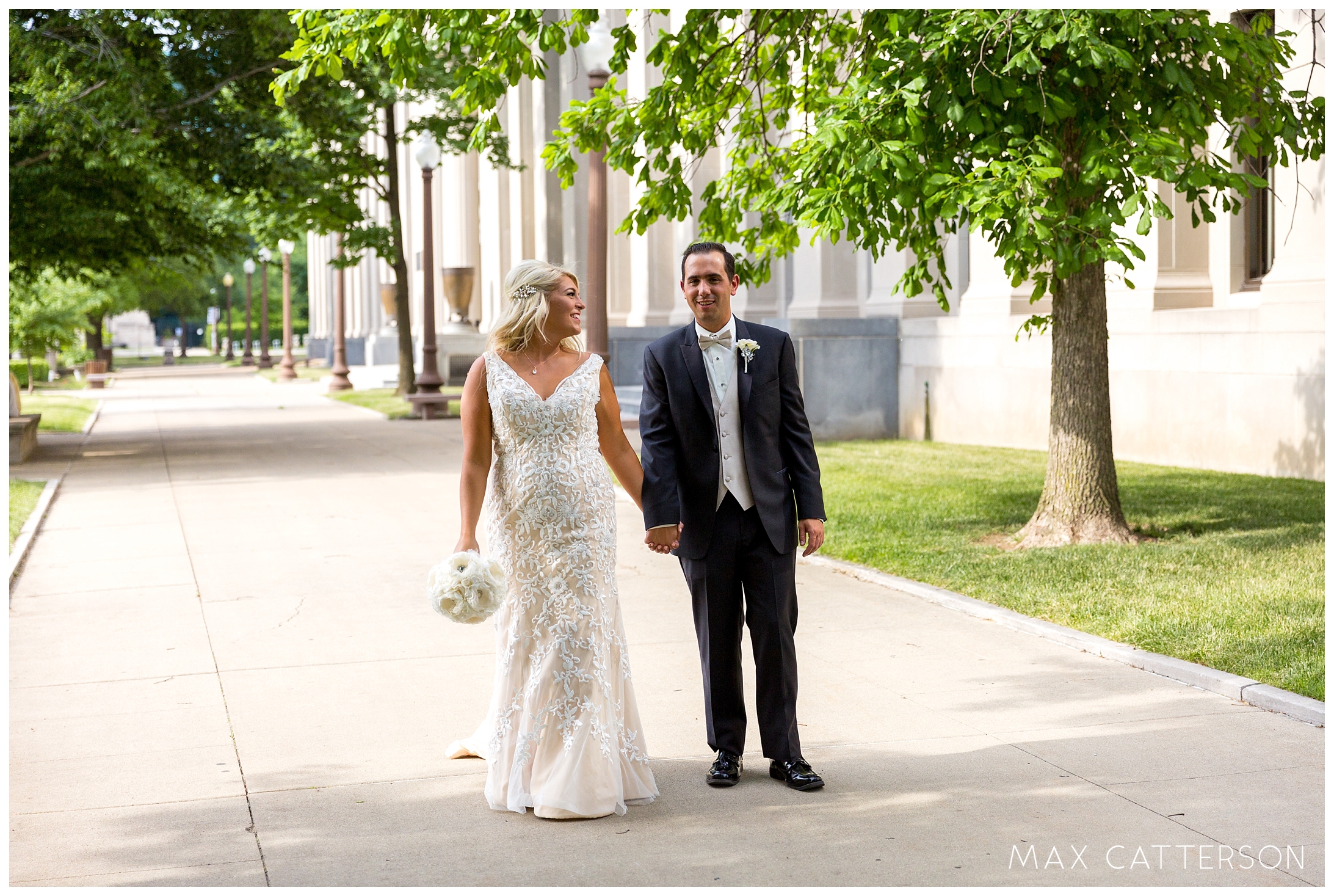 bride and groom walking on sidewalk