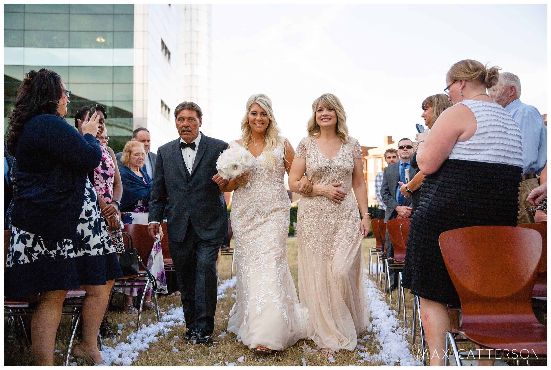 bride walking down the isle with her parents