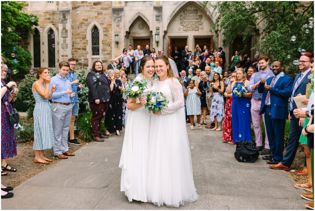 Lesbian couple on their wedding day with wedding guests